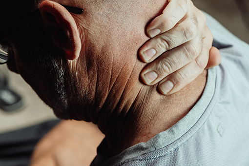 Man Experiencing Neck Pain In Need of Spinal Decompression Services in Fort Mill South Carolina