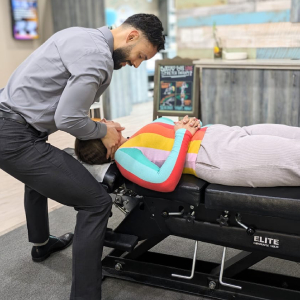 Pic of Dr. Juan Escobar Attending To a Patient Inside Pathway To Wellness Clinic