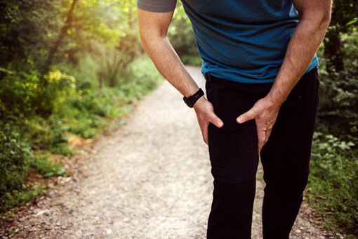 Man In Need of Knee Pain Treatment Having a Difficulty Walking on a Road in Fort Mill South Carolina